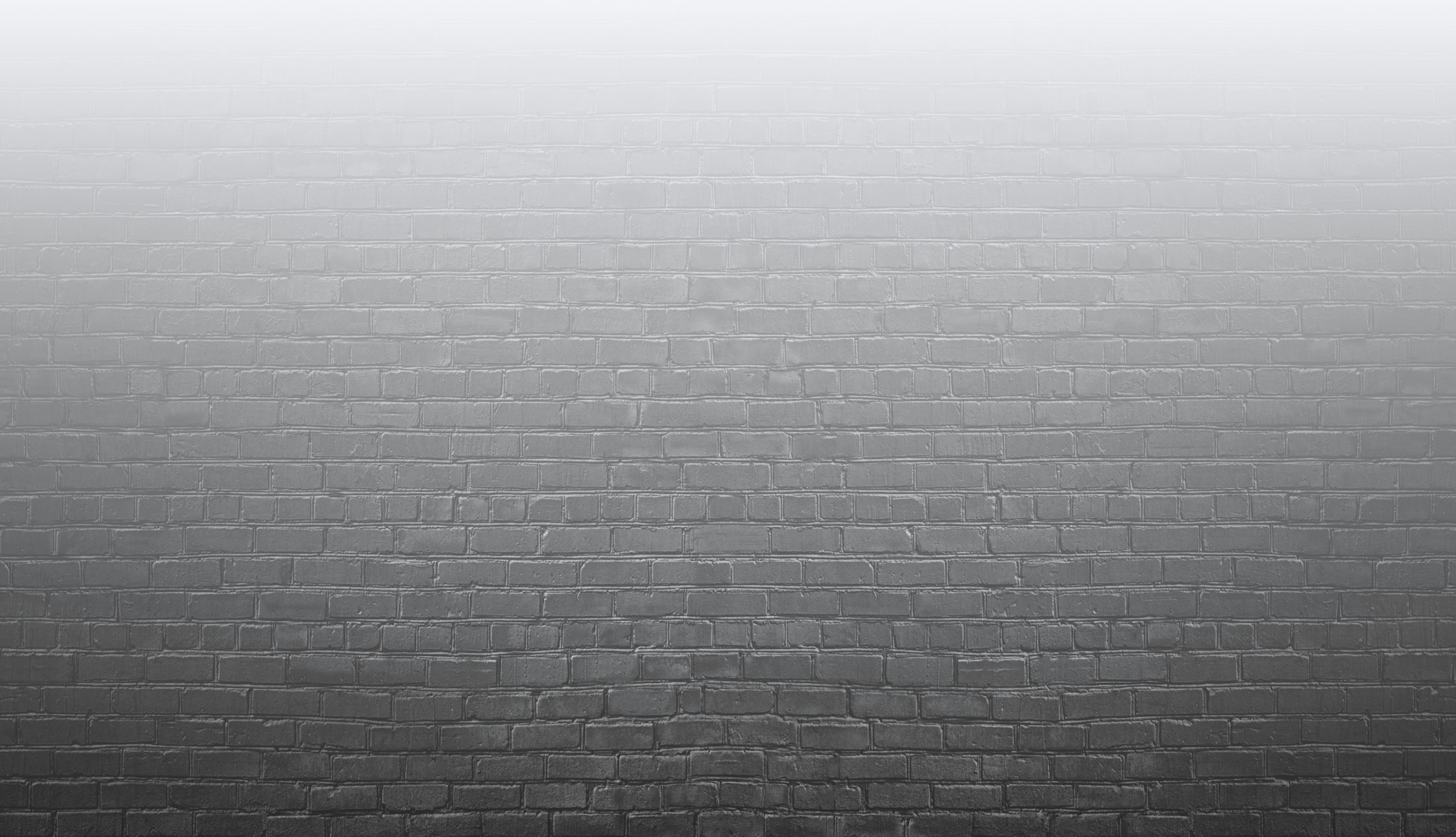 A foggy, gray brick wall without visible landmarks or people, creating a mysterious and atmospheric visual effect. The image focuses on texture.